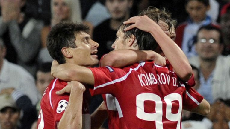 Dmitri Kombarov r celebrates with team-mates after his cross results in a Marseille own goal.