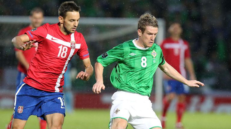 Northern Irelands Steven Davis right in action with Serbias Milos Ninkovic during the European Championship Qualifying match at Windsor Park, Belfast.