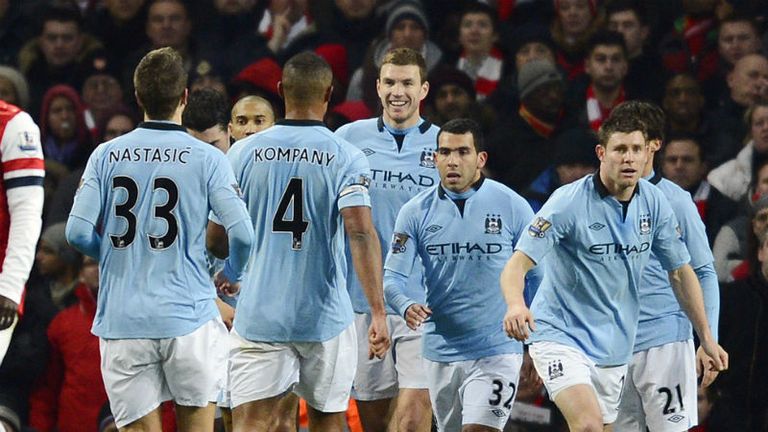 Edin Dzeko is congratulated by team-mates after scoring Manchester Citys second goal against Arsenal