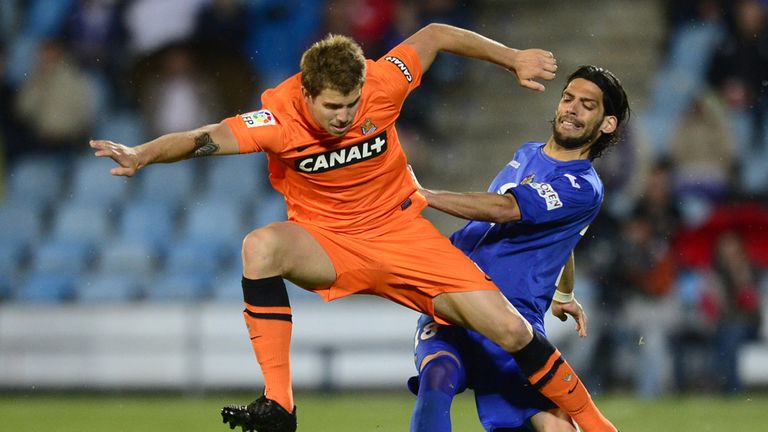 Getafe midfielder Angel Imanol Lafita vies with Real Sociedad defender Inigo Martinez 