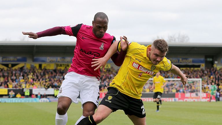 Bradford City's Kyel Reid  and Burton Albion's Alex MacDonald battle for the ball