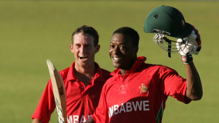 Zimbabwe's batsman Vusimuzi Sibanda celebrates reaching a century with team mate Sean Williams during the third an final ODI between Zimbabwe and Bangladesh