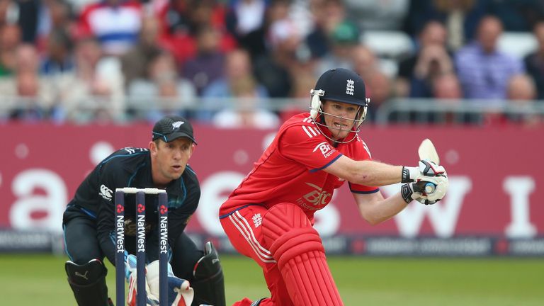 Eoin Morgan of England in action batting as Luke Ronchi of New Zealand looks on during the third ODI at Trent Bridge