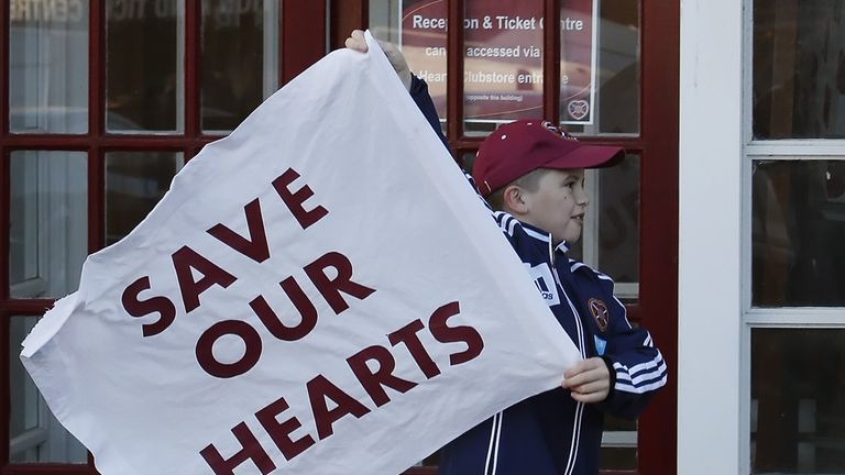 Hearts fan with flag outside Tynecastle