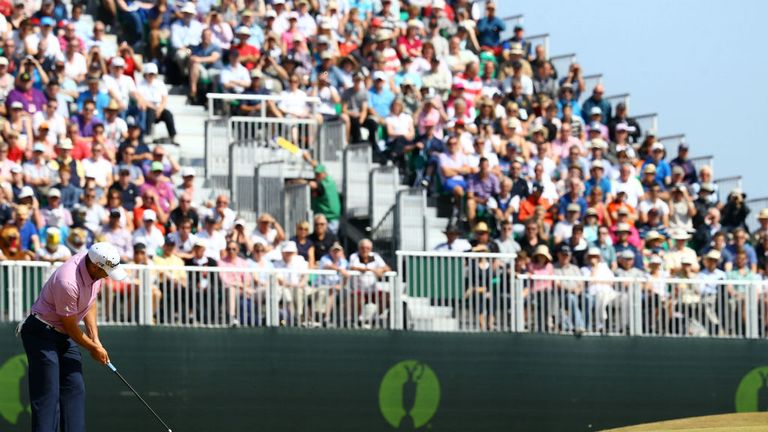 The Muirfield crowd looks on as Sergio Garcia putts