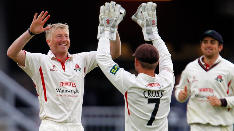 Glen Chapple (L) of Lancashire celebrates taking a wicket with team-mate Gareth Cross.
