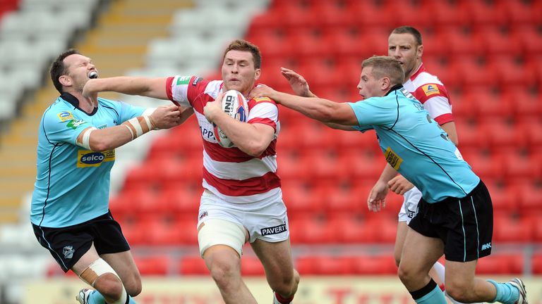 Scott Taylor of Wigan Warriors looks to break through the tackle of Mark Bryant and Jacob Fairbank of London Broncos during the Tetley's Challenge Cup semi-final