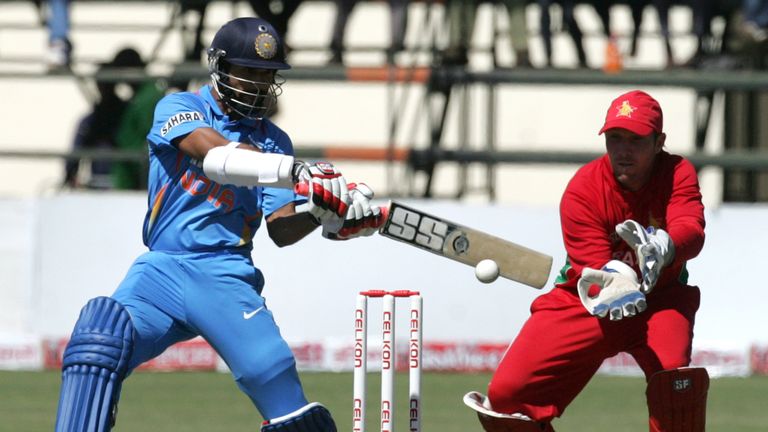 Indian batsman Shikhar Dhawan bats as Zimbabwean captain Brendan Taylor looks on during the second One Day International in the series in Harare