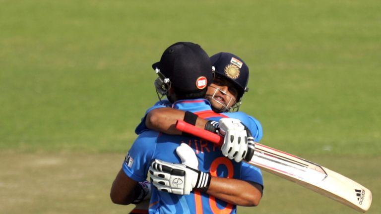 India's captain Virat Kohli (L) and teammate Suresh Raina embrace after victory during the 3rd match of the 5 cricket ODI series between Zimbabwe and India at Harare Sports Club on July 28, 2013