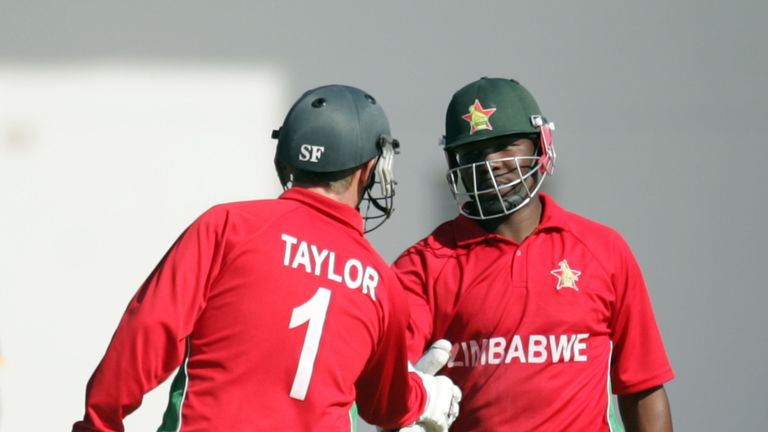Zimbabwe batsman Hamilton Masakadza (R) is congratulated by captain Brendan Taylor (L) on reaching 50 runs during the first game of the three match ODI cricket series between Pakistan and hosts Zimbabwe at the Harare Sports Club on August 27, 2013.