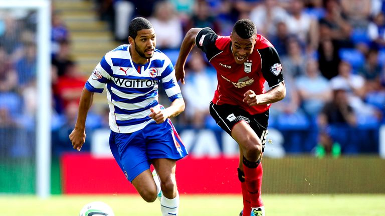 Jobi McAnuff of Reading runs away from Tyrone Mings of Ipswich during the Sky Bet Championship match between Reading and Ipswich Town at the Madejski Stadium on August 03, 2013.