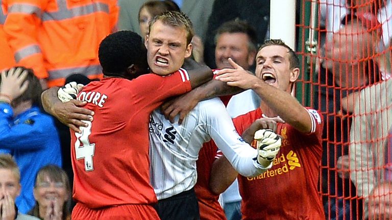 Simon Mignolet celebrates saving Jonathan Walters penalty