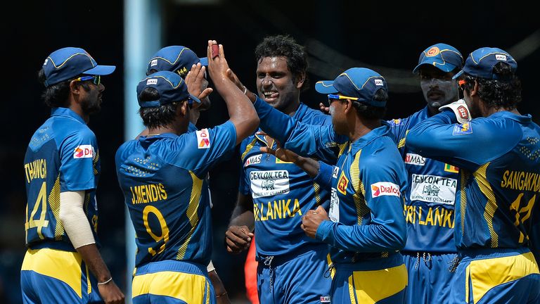 Sri Lankan cricket team captain  Angelo Mathews (C) celebrates with teammates after dismissing Indian batsman Shikhar Dhawan during the sixth match of the Tri-Nation series between India and Sri Lanka at the Queen's Park Oval stadium in Port of Spain on July 9, 2013