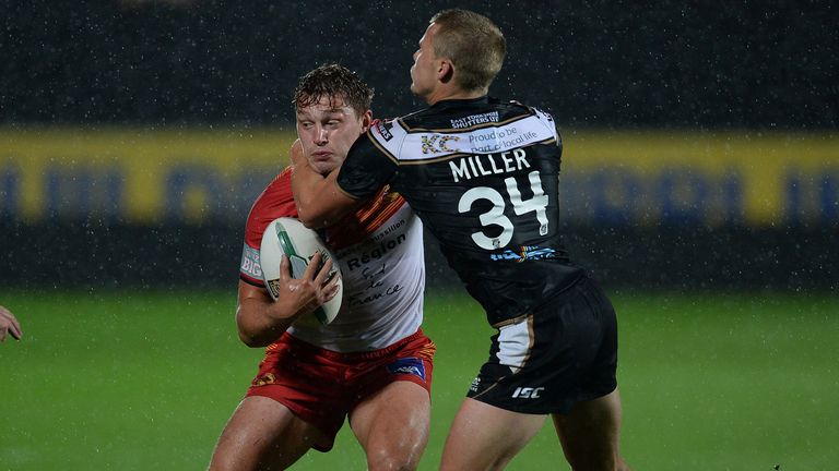 Elliott Whitehead of Catalan Dragons (L) is challenged by Jacob Miller of Hull FC during the Super League Play Off 