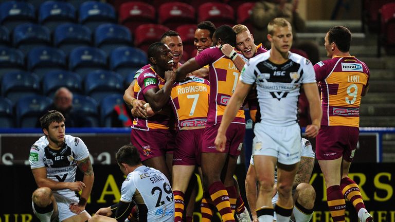 Huddersfield Giants' Luke Robinson celebrates with team-mates after scoring a try during the Super League Preliminary Semi Final against Hull FC