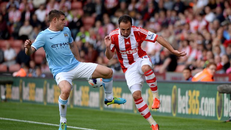 Matthew Etherington of Stoke is challenges by James Milner of Manchester City during the Barclays Premier League match between Stoke City and Manchester City at the Britannia Stadium 