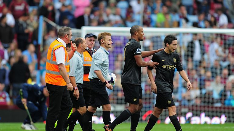 BIRMINGHAM, ENGLAND - SEPTEMBER 28:  Manchester City player Samir Nasri (r) is led away from referee Michael Jones (c) by captain Vincent Kompany during the Barclays Premier League match between Aston Villa and Manchester City at Villa Park on September 28, 2013 in Birmingham, England.  (Photo by Stu Forster/Getty Images)