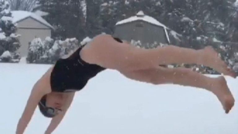 A resident dives into snow.