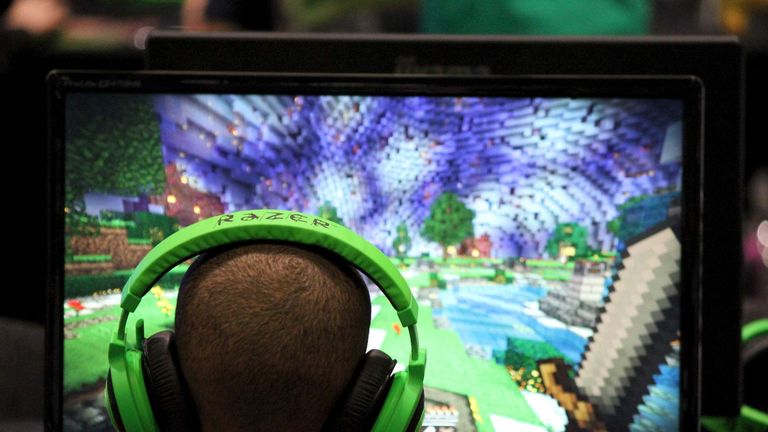 Child plays video game Minecraft at the Minecon convention in London
