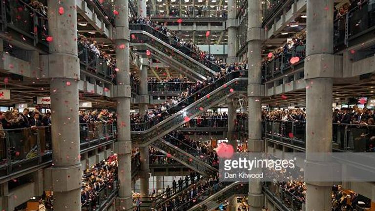 LONDON, ENGLAND - NOVEMBER 09: Poppies are dropped as brokers and underwriters line the balconies and escalators of the Lloyd's of London building during a service of Remembrance on November 9, 2018 in London, England. The service at Lloyd's is observed with the ringing of the Lutine Bell, the laying of wreaths before the Book of Remembrance and a two minute silence. The armistice ending the First World War between the Allies and Germany was signed at Compi??gne, France on eleventh hour of the eleventh day of the eleventh month - 11am on the 11th November 1918. Remembrance Day will be commemorated with special attention payed to this year's centenary (Photo by Dan Kitwood/Getty Images)