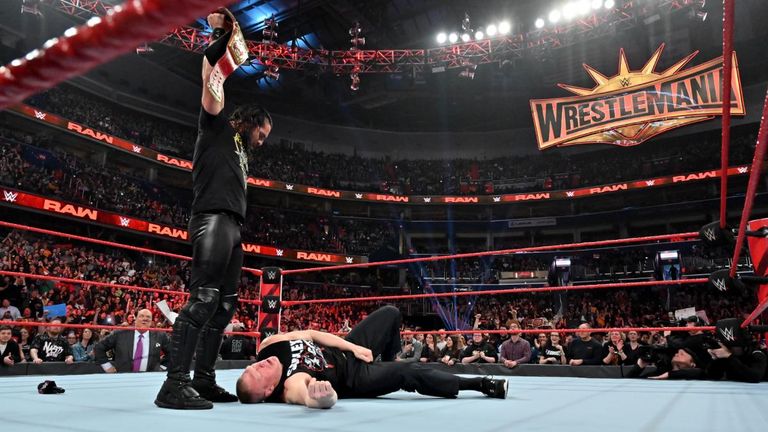 Seth Rollins put Brock Lesnar on the floor and raised the Universal title, for which they will compete at Wrestlemania on Sunday night